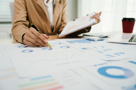 Businesswoman analyzing investment charts with laptop computer. Accounting,investment concept.の写真素材