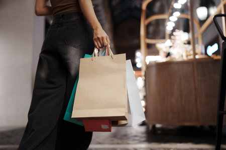 Close up of a woman holding shopping bags in the shopping mall.
