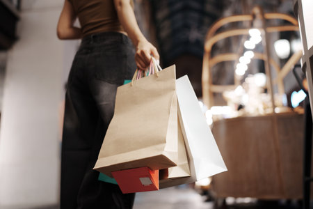 Shopping bags in the store. Close-up of a woman holding shopping bags