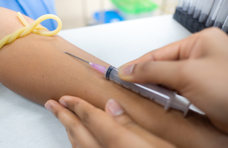 Medical technologist doing a blood draw services for patientの写真素材