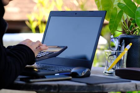 businessman using smartphone in the park and checking social networks, reading business newsの写真素材
