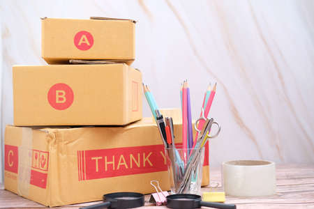 Parcel cardboard box packing on table. Online selling, e-commerce conceptの写真素材