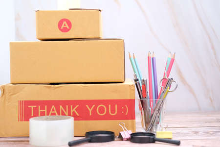Parcel cardboard box packing on table. Online selling, e-commerce conceptの写真素材