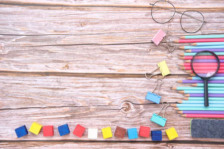 Back to school. Items for the school on a wooden table background and notebook space for textの写真素材