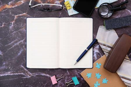 Notebook paper and mobile phone on wood table background and space for text
