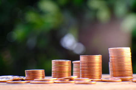 Coins on wooden table with blurred background, Business and financial concept.