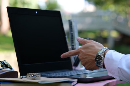 Close-up Of A Businessman's Hand Pointing At Computer Screen