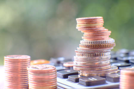 Coins stack on calculator, business finance and banking concept idea.の写真素材