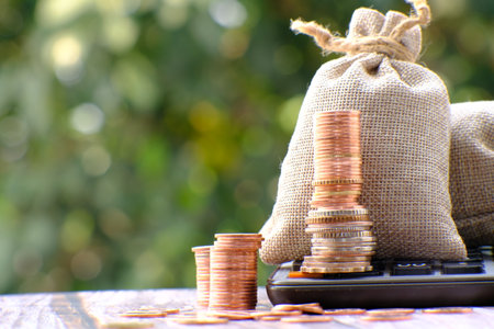 stacks of gold money coin on table background and concept saving money, business growth strategy of money concept, advertising coins of finance and bankingの写真素材