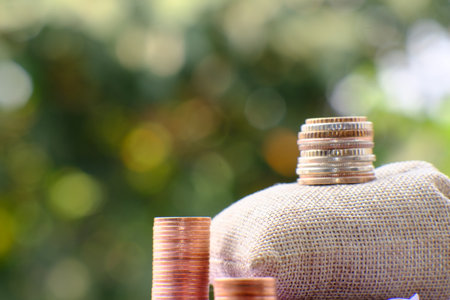 Coins stacked on each other in different positions, blurred background.の写真素材