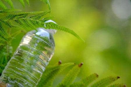 bottle of water in green natural background and spaceの写真素材