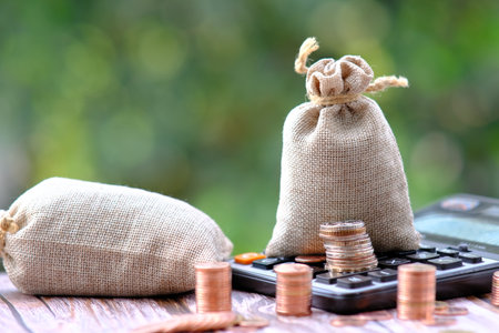 Stacks of gold money coin on table background and concept saving money, business growth strategy of money concept, advertising coins of finance and bankingの写真素材