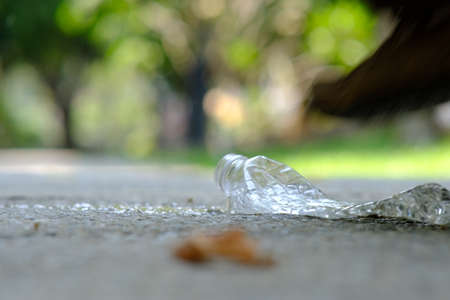 Plastic bottle on the ground in the park. Selective focus.の写真素材
