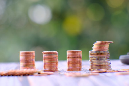 Coins stacked on each other with bokeh background, business growth conceptの写真素材
