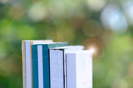 Books on a wooden table and Education learning concept with open book or textbook in library, stack piles of book on tableの写真素材