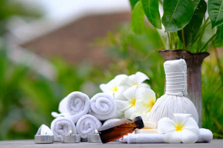 Spa treatments on old wooden table and candle light atmosphereの写真素材