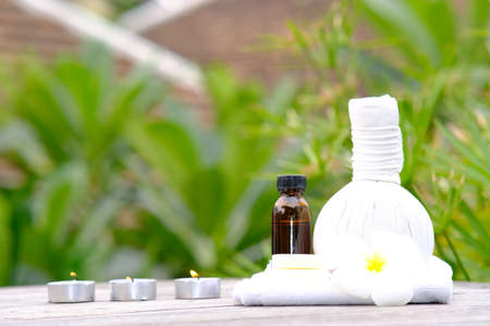 Spa treatments on wooden table and spa candle light atmosphere in wellness centre. beauty spa treatment and relax conceptの写真素材