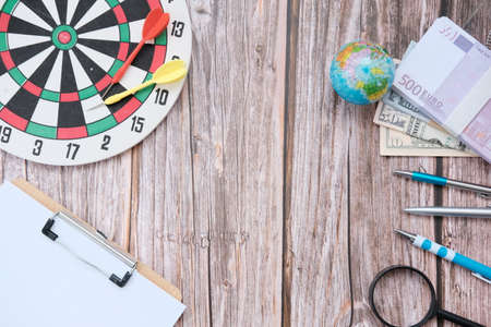 Dartboard with target on wood background and business growth concept business plan successful