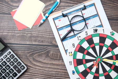 Dartboard with target on wood background and business growth concept business plan successfulの写真素材