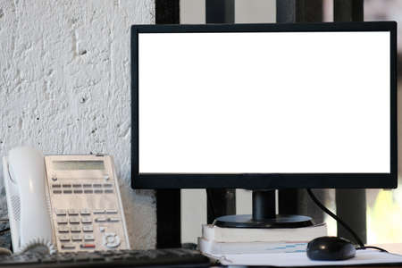 Computer on wood table and white screen for textの写真素材