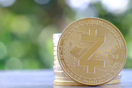 golden coin of zcash on green bokeh background.の写真素材