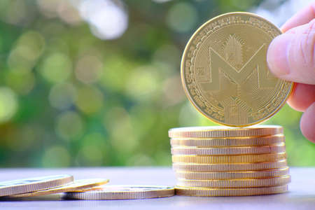Golden bitcoin coin with green bokeh background. Digital currency.の写真素材