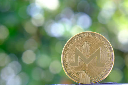 Digital currency physical golden monero coin. Cryptocurrency concept.の写真素材