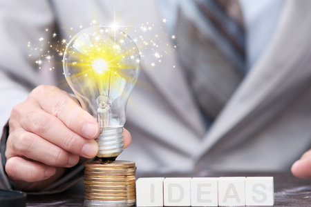 Businessman holding a light bulb with the word Ideas. Business conceptの写真素材