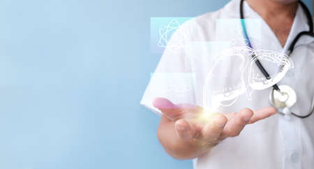 Health care and medical services concept. Doctor hand holding virtual hologram of human body on blue background.の写真素材