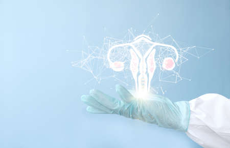 Female doctor holding glowing human organ on light blue background, closeup. Space for textの写真素材