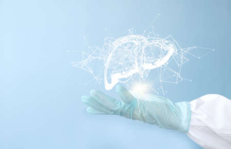 Hand in medical glove holding brain on light blue background, closeupの写真素材