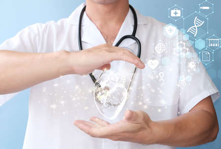 Health care and medical services concept. Doctor with stethoscope and heart on blue backgroundの写真素材
