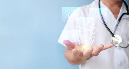 Doctor hand holding virtual screen on blue background, medical technology concept.