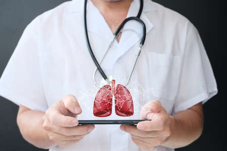 Close up of male doctor holding a digital tablet with human heart