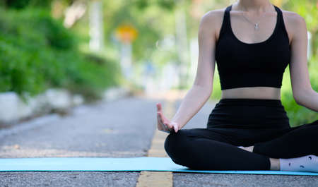 Young woman practicing yoga. Healthy lifestyle and relaxation concept.の写真素材