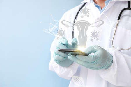 Doctor with stethoscope holding smartphone on light blue background, closeup. Space for textの写真素材