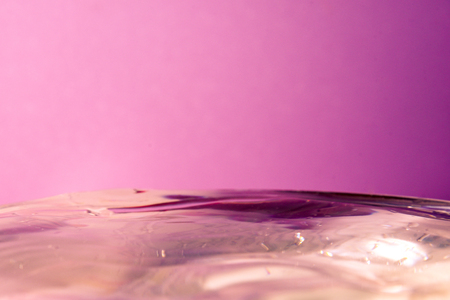 Drop of water falling in blue water and blue background.の写真素材