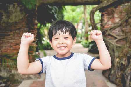 Portrait of a cute little Asia boy smiling . Portrait of young boy in nature,park or outdoors.の写真素材