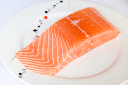 Salmon in white dish on white blackgroundの写真素材