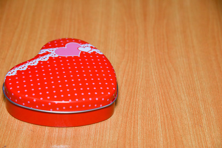 Red Heart shape gift box on wooden table . Valentines Day background , wedding day.の写真素材