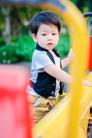Cute little  Asian boy having fun on a playground outdoors , Happy kidsの写真素材