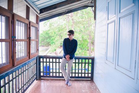 portrait of men with blue shirt  in the old house. Young businessman standingの写真素材