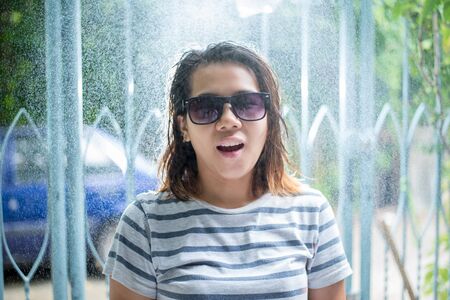 The rain falls, the drops fall on his face and the girl is happy with life and nature around,...