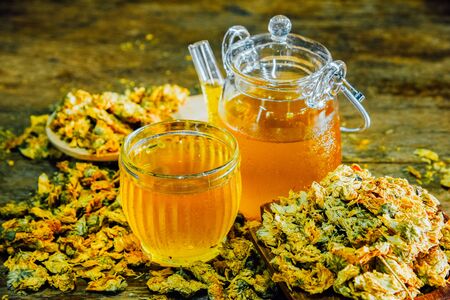 Chinese Chrysanthemum Tea in cup and  teapot on wood table, health herbal tea.の写真素材
