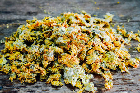 Chinese Chrysanthemum Tea on old wooden table, health herbal tea.