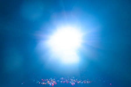 Blue light flare special effect and beads on black background , concert lighting .