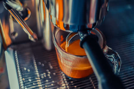 Barista making an americano shot coffee , Machine into cup glass, close-upの写真素材