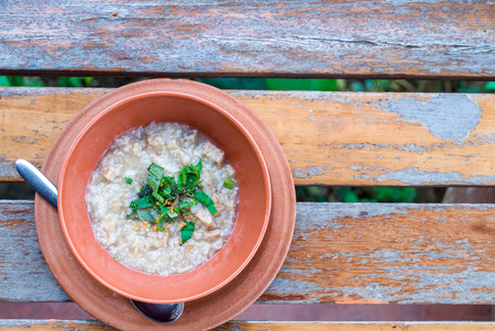 Pork porridge in terracotta pot