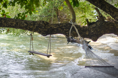 White cradle tied to the beach beach treeの写真素材