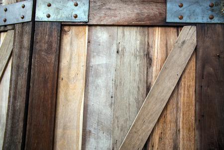 The wooden door background image has a wooden pad placed alternately.の写真素材